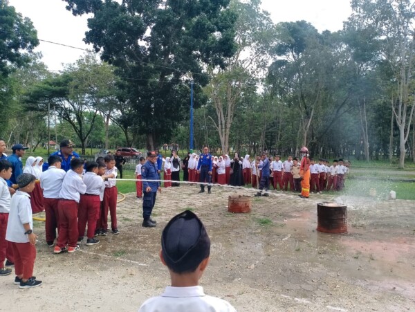 Para murid SD IT Asy Syamil Konawe ketika menerima edukasi cara memadamkan kobaran api dari personel Damkar setempat, kemarin.