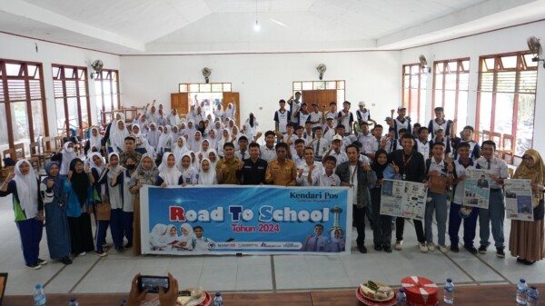 Kepala SMKN 4 Kendari, Dr. Herman (10 dari kanan), Pemred Kendari Pos, Inong Saputra (11 dari kanan) bersama guru dan siswa-siswi SMKN 4 Kendari dalam kegiatan road to school Kendari Pos, Selasa (30/1/2024). (MUH. ABDI ASMAUL AMRIN/KENDARI POS)